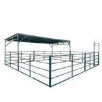 12ft by 24ft modular livestock shelter with green metal roof canopy and corral panel fencing for cattle and horse protection