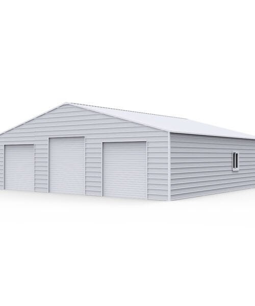 Large white metal storage building with multiple doors and a small window.