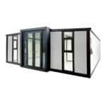 Modern modular steel container home with glass doors and windows.