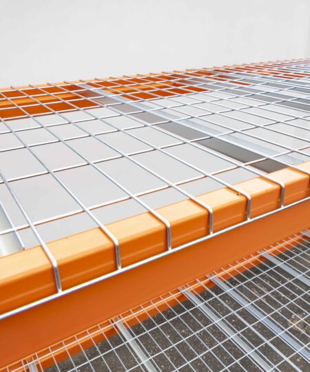 Heavy-duty industrial pallet rack with safety features and wire mesh decking.